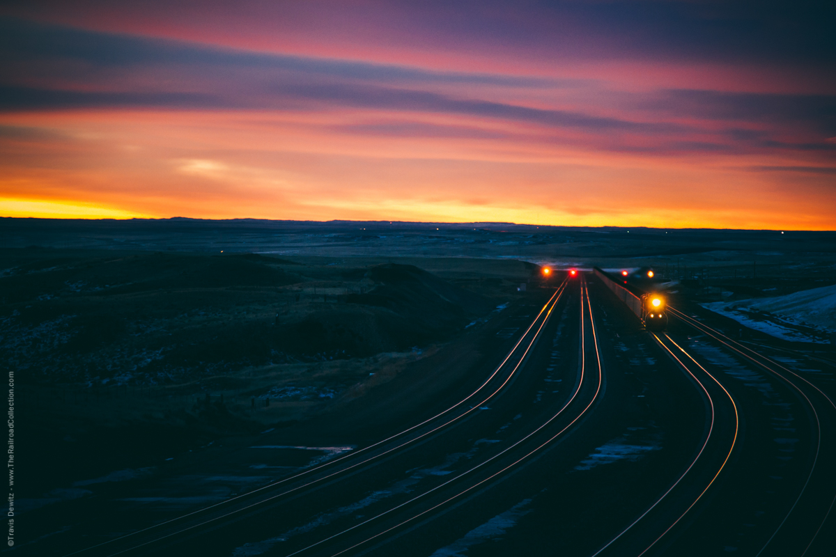 One of the busiest railroad locations in the United States is the Powder River Basin. There can be over one hundred trains a day hauling forty percent of the nations coal demands. These are the the four tracks that cross over Logan Hill just north of Bill, Wyoming on BNSF's Orin Subdivision. This is the view looking south on one of the toughest grades in the basin. This line started as a single track owned by the Burlington Northern which was constructed between 1972 to 1979.