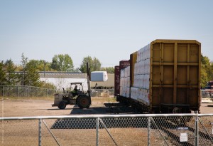 An Automated Building Components (ABC) employee unloads lumber off a bulkhead car that Wisconsin Northern delivered in Chetek, Wisconsin.