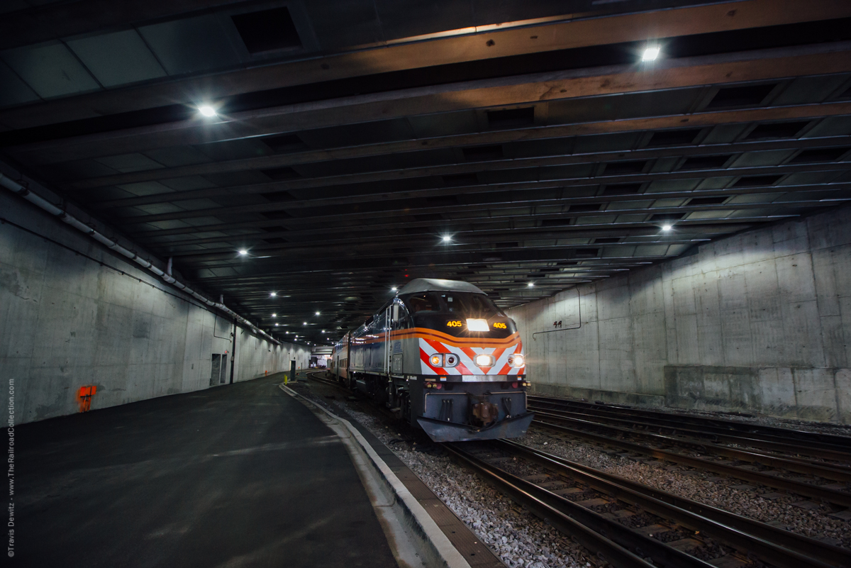 An outbound Metra passenger train departs the northside of Chicago Union Station. This view is from under the new River Point office building construction. This will be a 52 story ultra modern office building located at 444 West Lake Street. River Point sits over the tracks in a triangle shaped parcel that is between Lake St., Canal St. and the Chicago River. The south side of this tower now stands were Amtrak's Lake Street Tower once stood. Metra 405 is about to hit daylight and cross over Canal Street.