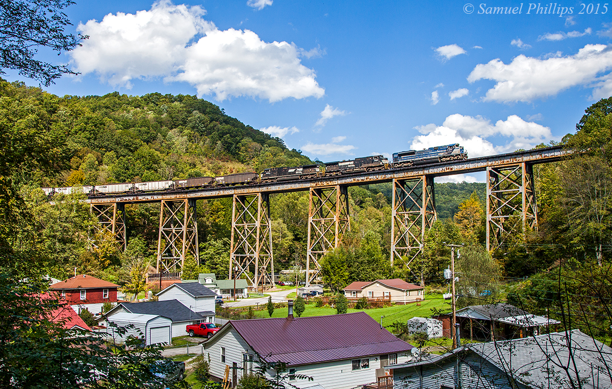 On a beautiful afternoon, train U86 grinds upgrade across the trestle at Covel led by EMDX SD70ACe demonstrator No. 2012 with a utility train in tow en-route to the Belews Creek Steam Staion near Winston-Salem, N.C. Most of the time, trains in this area will only run with NS power, but every now and then, something odd ball like this will pop up and surprise you.