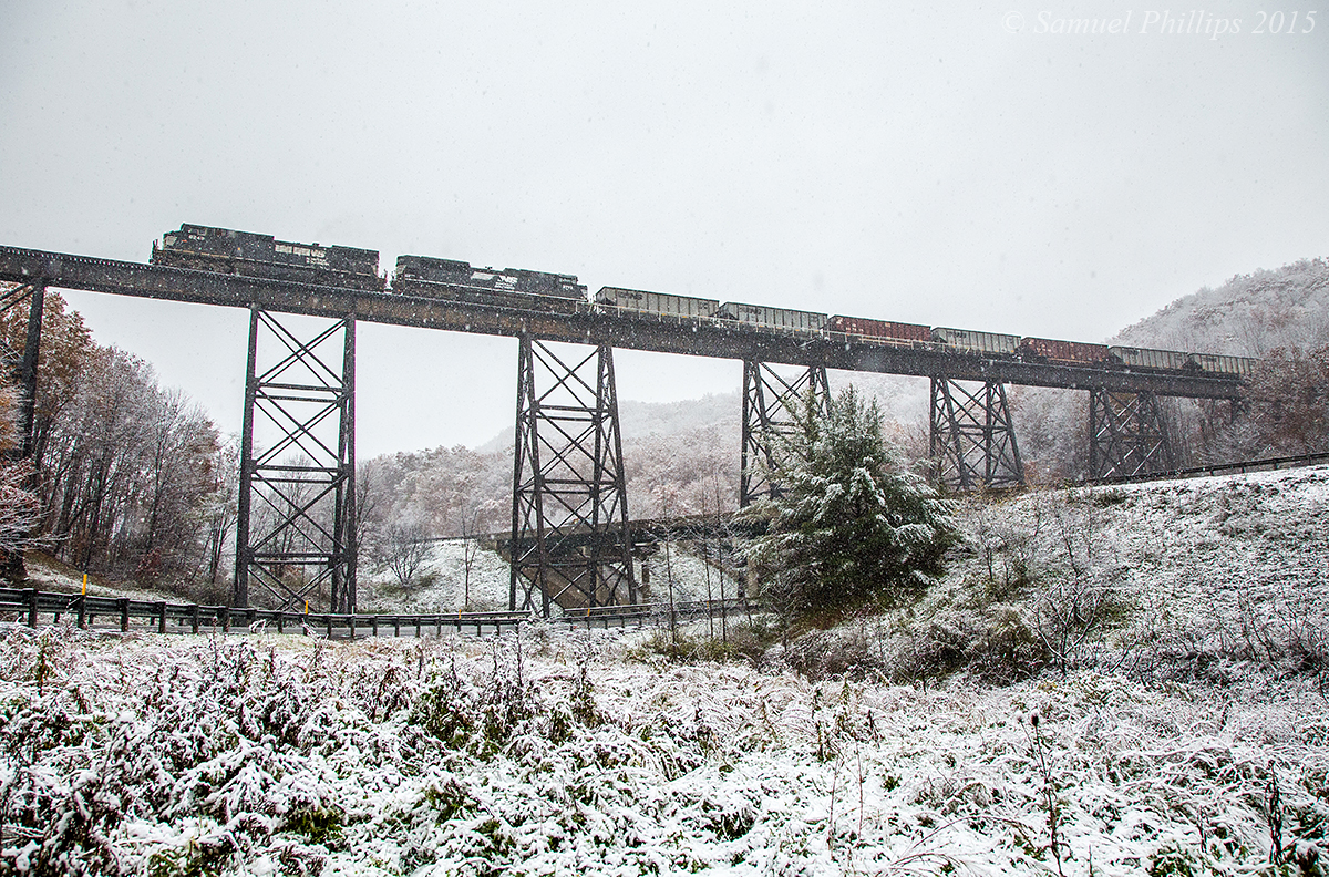 Train U86 with a long string of empties in tow crawls across the trestle at Ingleside soaring high above I-77 with light snow falling. The two locomotives are really struggling to maintain traction with the tough winter conditions making the ascent to Princeton much more difficult than usual. 