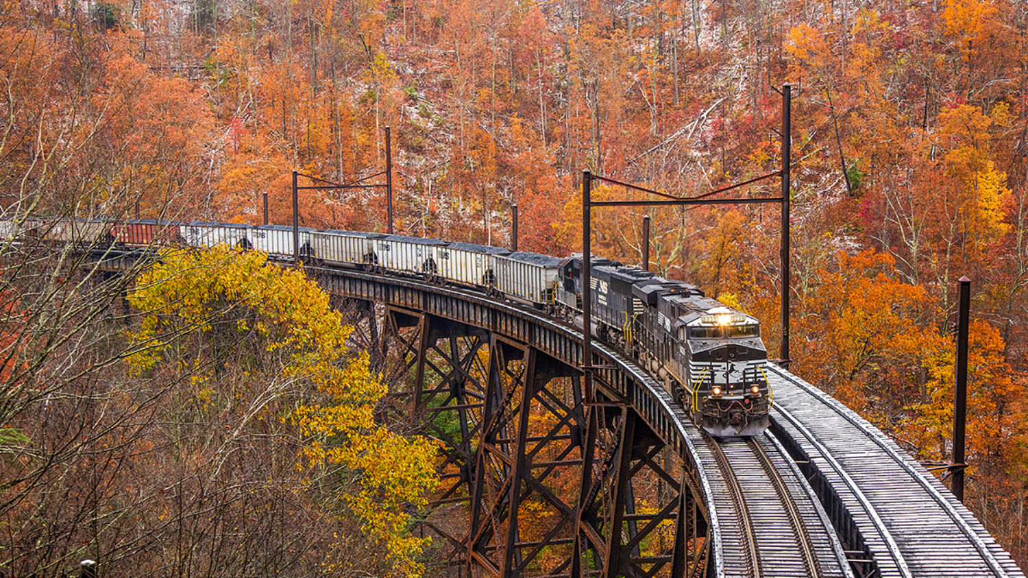 Stunning fall color and trace of snow off set this beautiful scene at Garwood, as train U87 grinds across the trestle with the first of two hill runs going to Clark’s Gap. No. 8039 is leading the charge with one other locomotive in tow. The train is only around 60 loads, hence the 5 locomotive consist. 