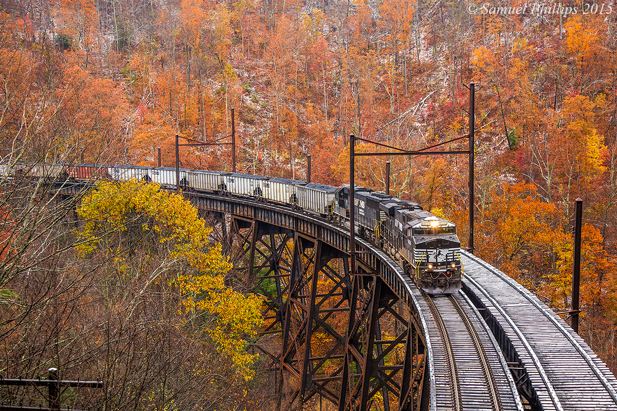 Stunning fall color and trace of snow off set this beautiful scene at Garwood, as train U87 grinds across the trestle with the first of two hill runs going to Clark’s Gap. No. 8039 is leading the charge with one other locomotive in tow. The train is only around 60 loads, hence the 5 locomotive consist. 